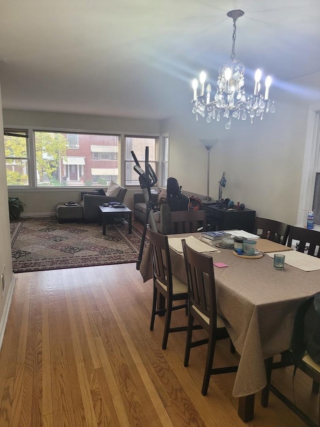 dining room featuring wood finished floors and a chandelier