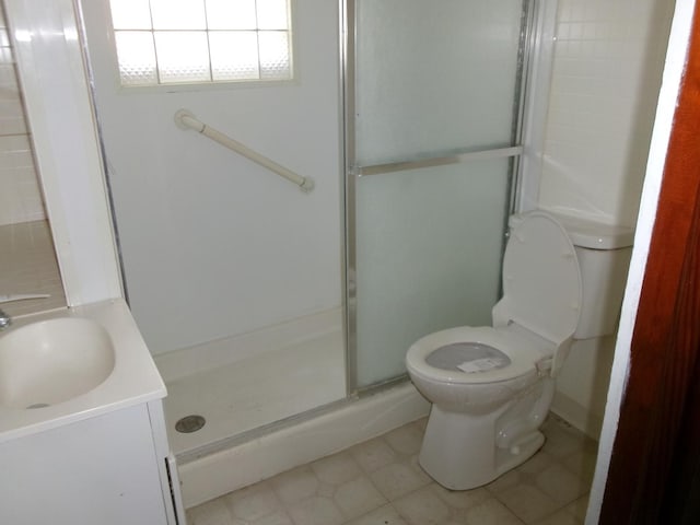 bathroom with vanity, a stall shower, and toilet