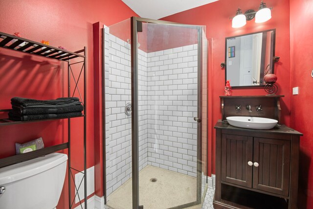 full bathroom featuring toilet, a shower stall, and vanity