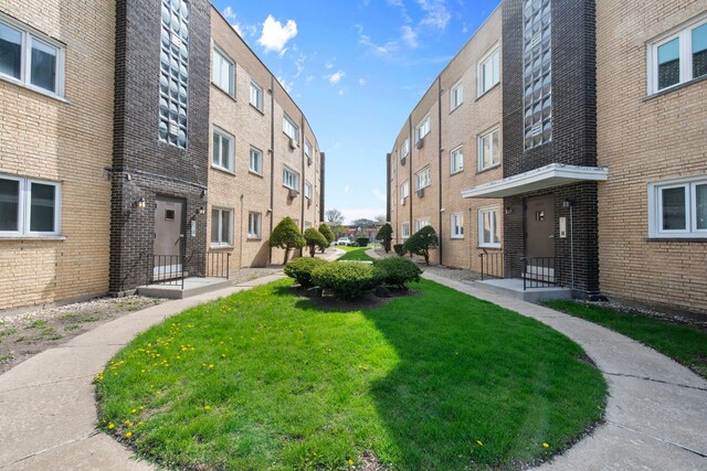 view of community with a yard and a residential view