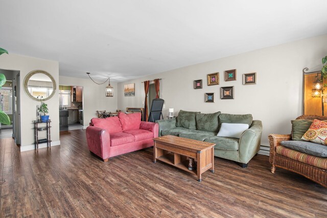 living room with wood finished floors and a chandelier