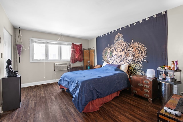 bedroom featuring baseboards, a wall mounted air conditioner, and wood finished floors