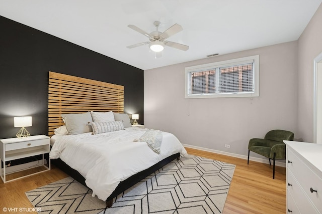 bedroom with baseboards, visible vents, multiple windows, and light wood-type flooring