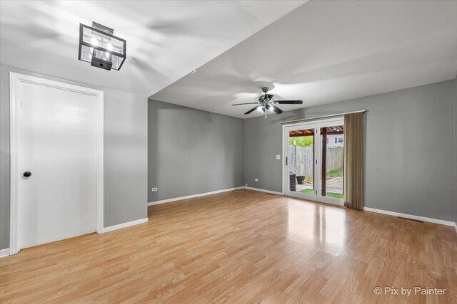 empty room featuring baseboards, a ceiling fan, and light wood finished floors