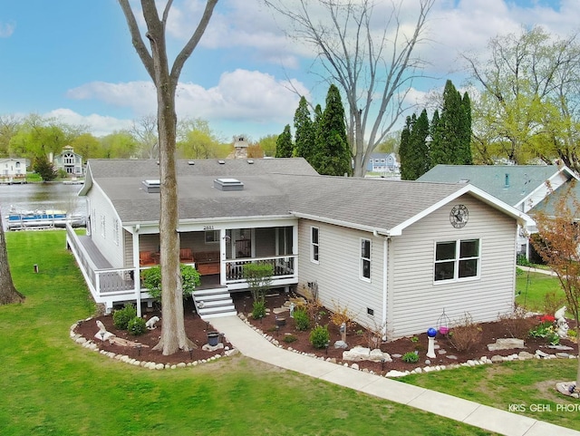 2601 N Villa Ln, Mchenry, IL 60051 - view of front of house featuring roof with shingles, a front lawn, a chimney, and a sunroom