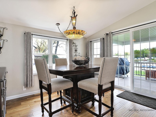 2601 N Villa Ln, Mchenry, IL 60051 - dining area featuring healthy amount of natural light, light wood-style flooring, lofted ceiling, and baseboards