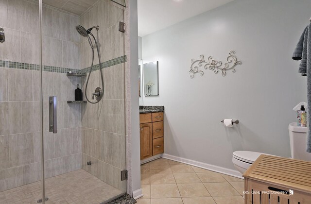 2601 N Villa Ln, Mchenry, IL 60051 - bathroom with a shower stall, tile patterned floors, toilet, vanity, and baseboards