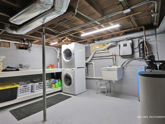 2601 N Villa Ln, Mchenry, IL 60051 - unfinished below grade area with stacked washer / drying machine, gas water heater, and a sink