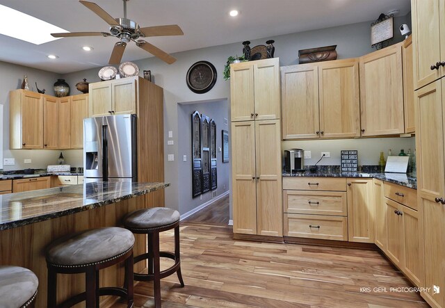 2601 N Villa Ln, Mchenry, IL 60051 - kitchen featuring stainless steel fridge, light brown cabinets, a breakfast bar, light wood-type flooring, and recessed lighting