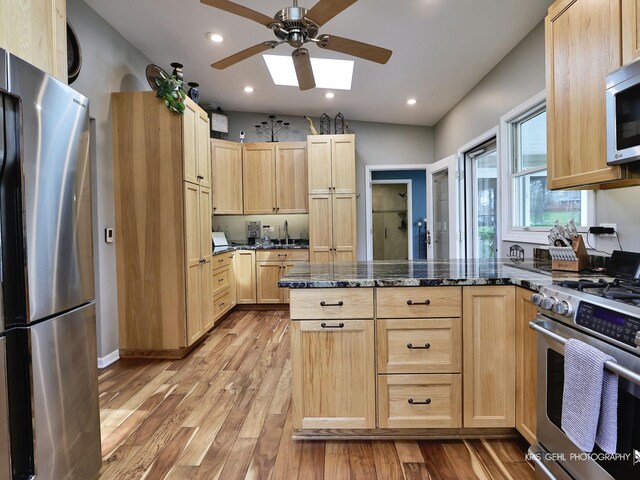 2601 N Villa Ln, Mchenry, IL 60051 - kitchen featuring appliances with stainless steel finishes, light brown cabinets, a peninsula, light wood-style flooring, and recessed lighting