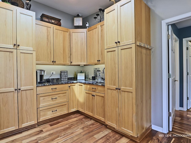 2601 N Villa Ln, Mchenry, IL 60051 - kitchen with light brown cabinetry, wood finished floors, and dark stone counters