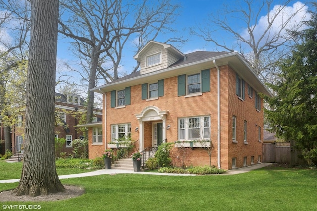 2334 Central Park Ave, Evanston, IL 60201 - view of front of house with fence, a front lawn, and brick siding