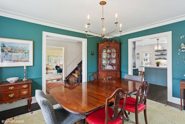 2334 Central Park Ave, Evanston, IL 60201 - dining room featuring crown molding, wood finished floors, stairway, baseboards, and an inviting chandelier