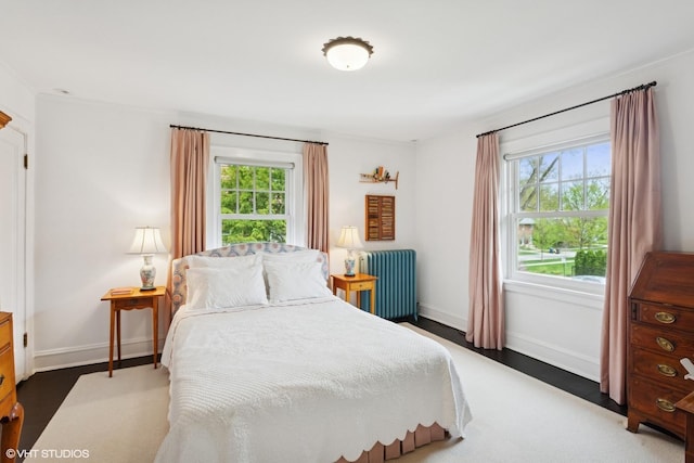 2334 Central Park Ave, Evanston, IL 60201 - bedroom with baseboards, radiator heating unit, and wood finished floors