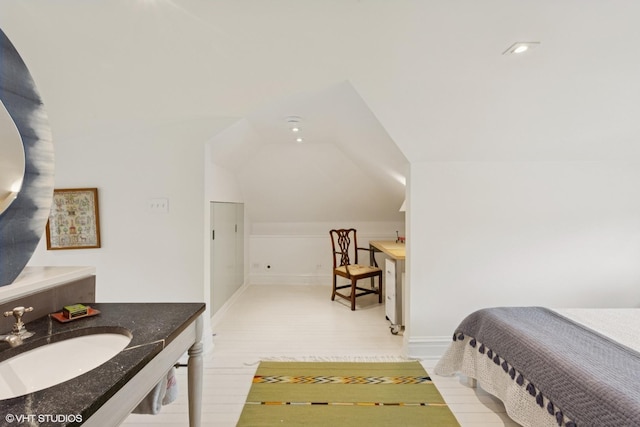 2334 Central Park Ave, Evanston, IL 60201 - bedroom featuring baseboards, vaulted ceiling, a sink, and light wood finished floors