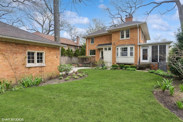 2334 Central Park Ave, Evanston, IL 60201 - back of property featuring a yard, brick siding, a chimney, and entry steps