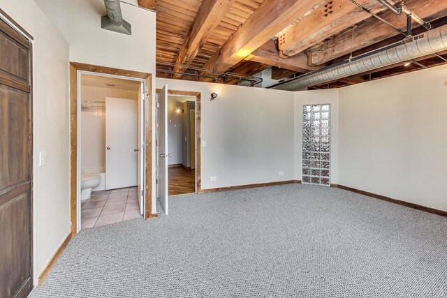 unfurnished bedroom with light tile patterned flooring, baseboards, light colored carpet, and ensuite bathroom