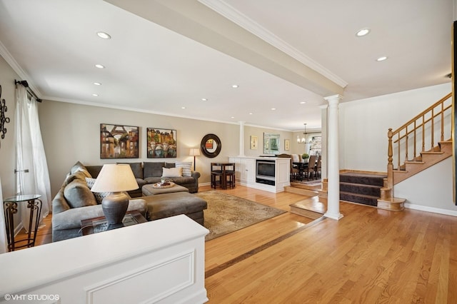living area featuring crown molding, stairway, recessed lighting, ornate columns, and light wood finished floors