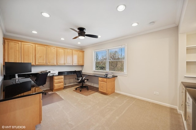 home office with ceiling fan, light colored carpet, built in desk, recessed lighting, and ornamental molding