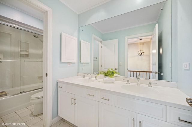 bathroom featuring crown molding, a sink, tile patterned floors, and toilet