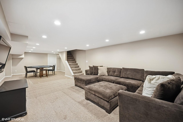 living area with stairs, recessed lighting, baseboards, and light colored carpet