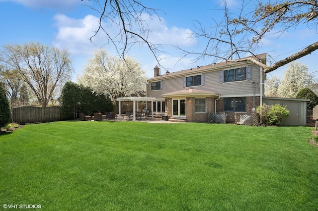 rear view of property with fence, a pergola, a chimney, a patio area, and a yard
