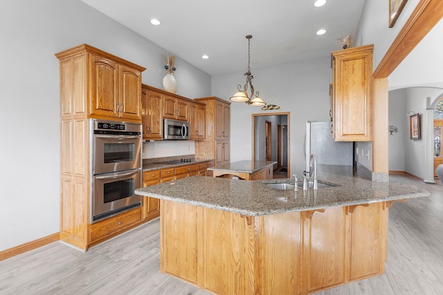 400 Rock Creek Dr, Manteno, IL 60950 - kitchen with a sink, appliances with stainless steel finishes, a peninsula, and light wood-type flooring