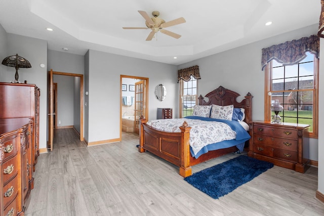 400 Rock Creek Dr, Manteno, IL 60950 - bedroom with baseboards, a raised ceiling, and light wood-style floors