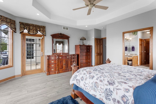 400 Rock Creek Dr, Manteno, IL 60950 - bedroom featuring access to outside, light wood-style flooring, recessed lighting, a tray ceiling, and visible vents