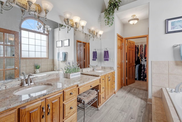 400 Rock Creek Dr, Manteno, IL 60950 - full bath featuring double vanity, a sink, a garden tub, and wood finished floors