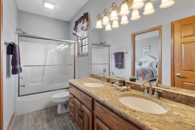400 Rock Creek Dr, Manteno, IL 60950 - ensuite bathroom with double vanity, toilet, a sink, and wood finished floors