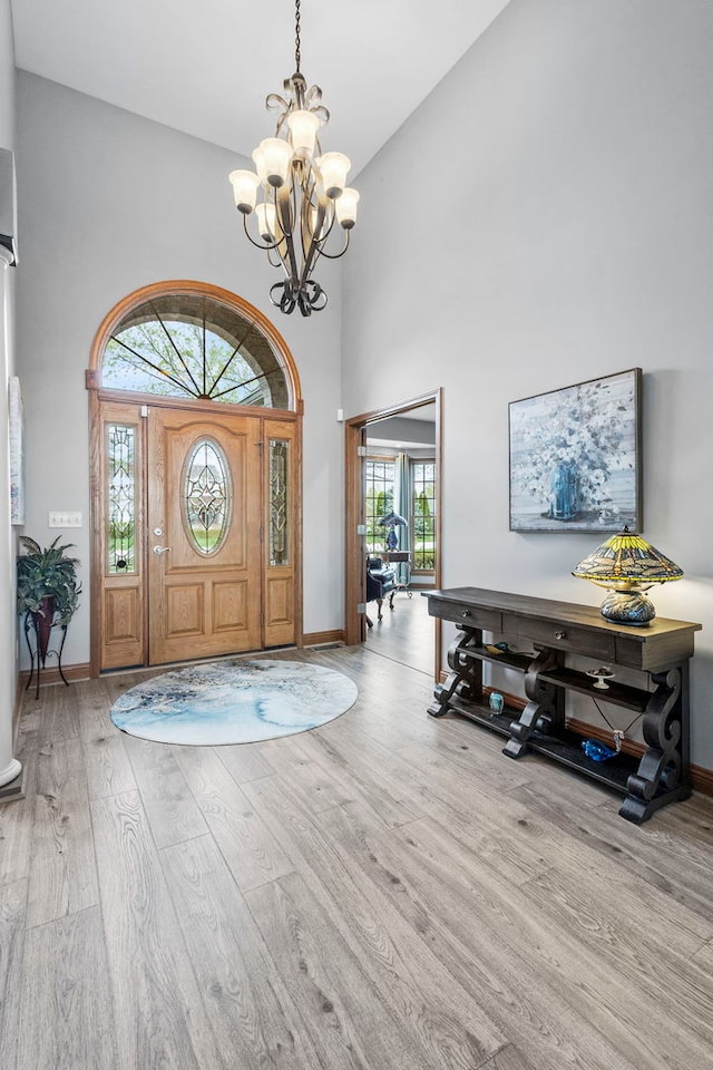 400 Rock Creek Dr, Manteno, IL 60950 - foyer featuring baseboards, a notable chandelier, wood finished floors, and a towering ceiling