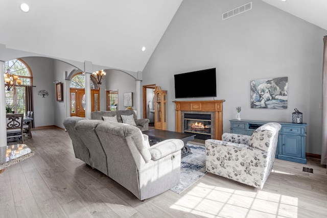 400 Rock Creek Dr, Manteno, IL 60950 - living room with arched walkways, light wood finished floors, high vaulted ceiling, and visible vents