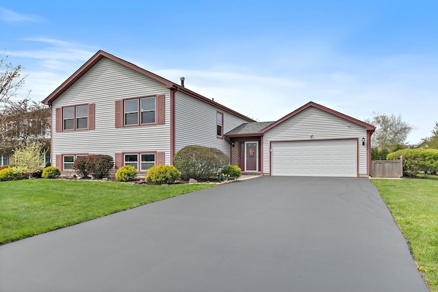 705 Old Mill Grove Rd, Lake Zurich, IL 60047 - tri-level home featuring an attached garage, a front lawn, and aphalt driveway