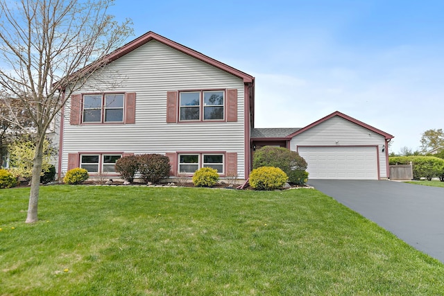 705 Old Mill Grove Rd, Lake Zurich, IL 60047 - split level home featuring an attached garage, a front yard, and aphalt driveway