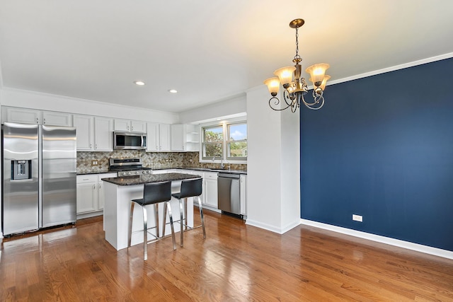 705 Old Mill Grove Rd, Lake Zurich, IL 60047 - kitchen with a kitchen island, a kitchen bar, appliances with stainless steel finishes, tasteful backsplash, and a chandelier