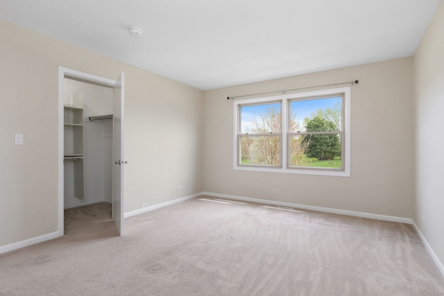 705 Old Mill Grove Rd, Lake Zurich, IL 60047 - unfurnished bedroom featuring baseboards, a walk in closet, carpet, and a closet