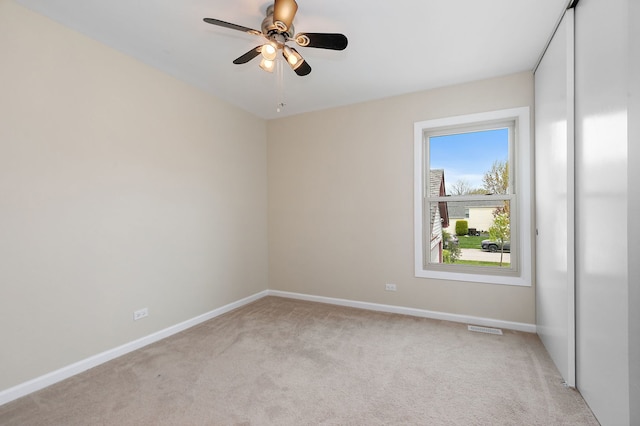 705 Old Mill Grove Rd, Lake Zurich, IL 60047 - spare room with a ceiling fan, baseboards, visible vents, and light carpet
