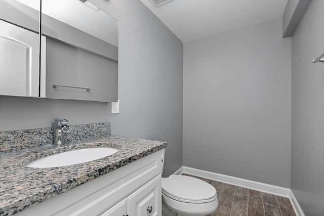 705 Old Mill Grove Rd, Lake Zurich, IL 60047 - bathroom featuring wood finish floors, vanity, toilet, baseboards, and visible vents