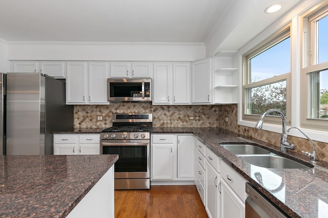 705 Old Mill Grove Rd, Lake Zurich, IL 60047 - kitchen featuring crown molding, dark stone counters, white cabinets, a sink, and stainless steel appliances