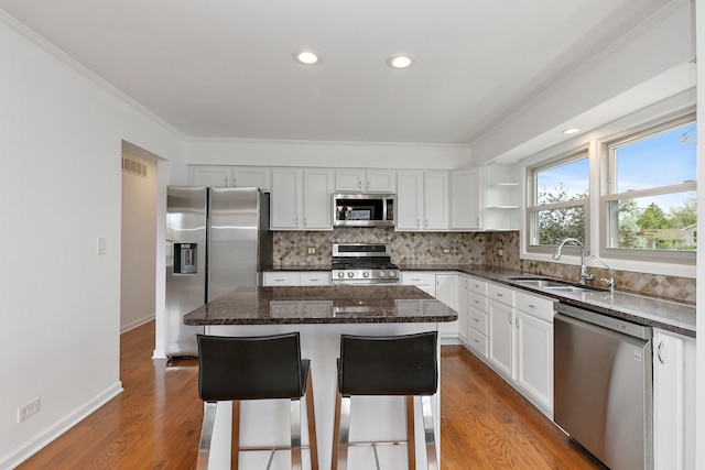 705 Old Mill Grove Rd, Lake Zurich, IL 60047 - kitchen featuring a sink, stainless steel appliances, wood finished floors, tasteful backsplash, and visible vents