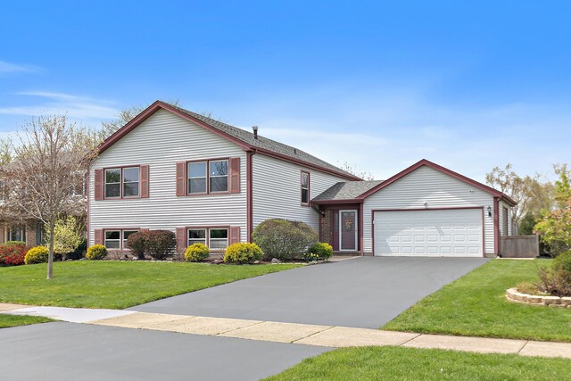 705 Old Mill Grove Rd, Lake Zurich, IL 60047 - split level home with driveway, a shingled roof, a front lawn, and a garage