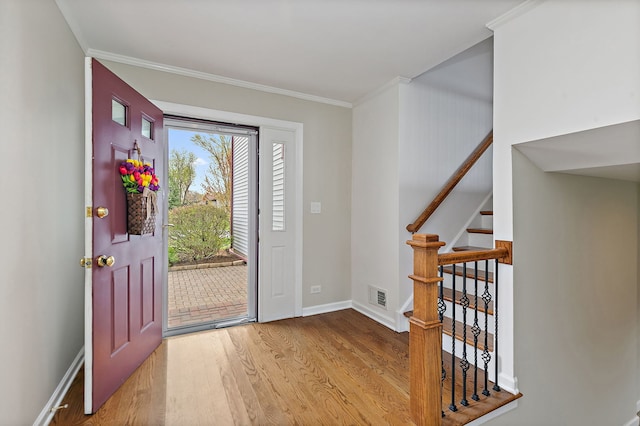 705 Old Mill Grove Rd, Lake Zurich, IL 60047 - entrance foyer with visible vents, ornamental molding, wood finished floors, baseboards, and stairway
