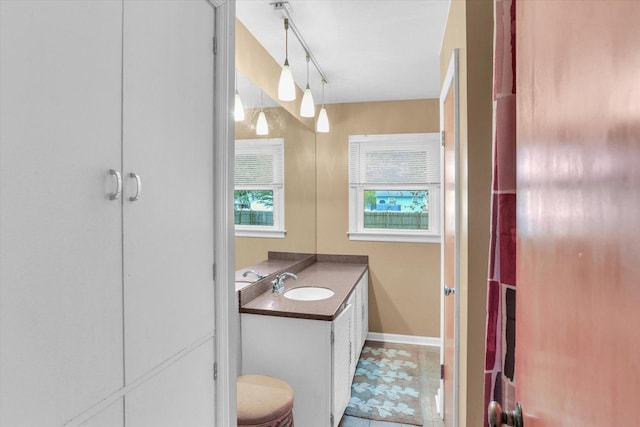 bathroom featuring vanity and baseboards