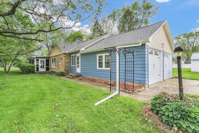 view of front facade with a chimney, a front yard, a sunroom, a shingled roof, and entry steps