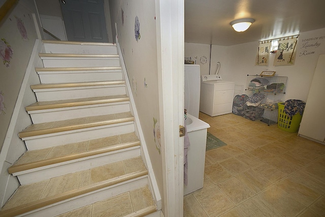 stairs featuring washing machine and dryer