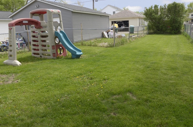 view of play area with fence and a yard