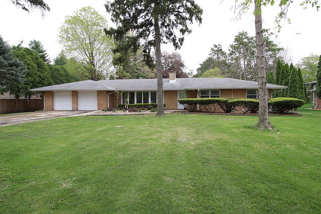single story home featuring an attached garage, brick siding, a front yard, a chimney, and driveway