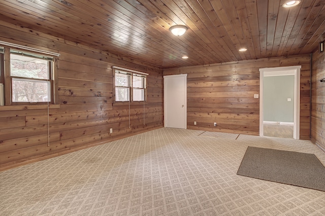 carpeted spare room featuring wooden walls, recessed lighting, and wooden ceiling