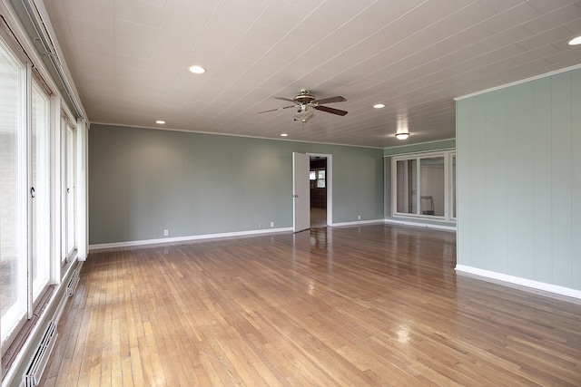 unfurnished room with recessed lighting, hardwood / wood-style flooring, and a wealth of natural light